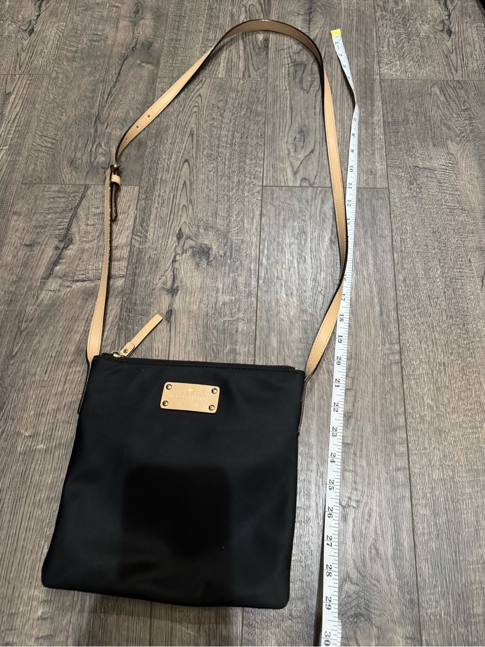 kate spade Black Nylon Crossbody with Tan Leather Strap, the inside has a rip